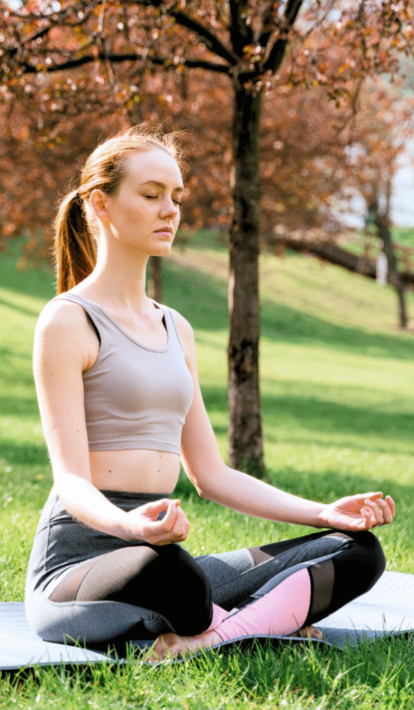 A girl doing yoga in greenery